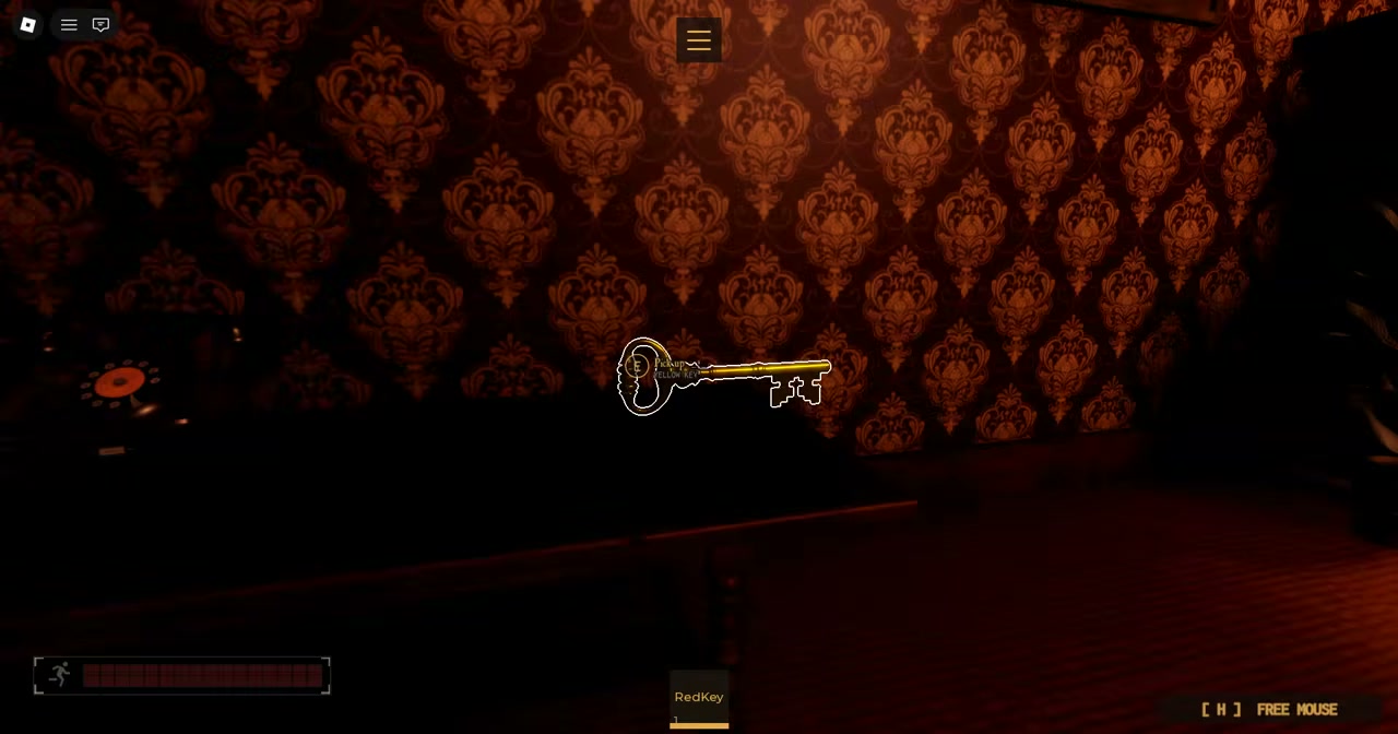 In-game view of glowing red key on floor with Red Key pickup prompt